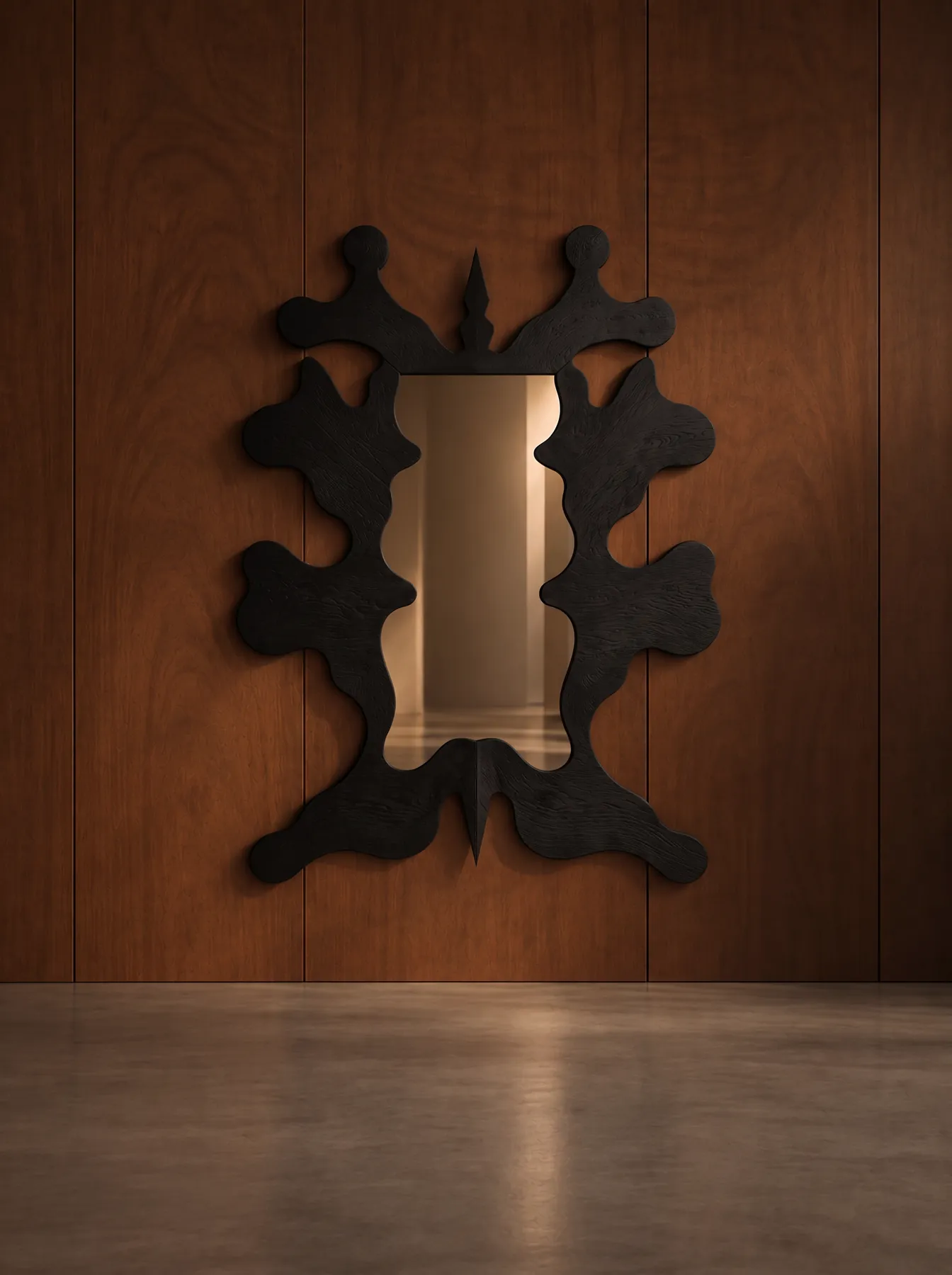 Inkblot Mirror with a charred oak blob-shaped frame on walnut panelling