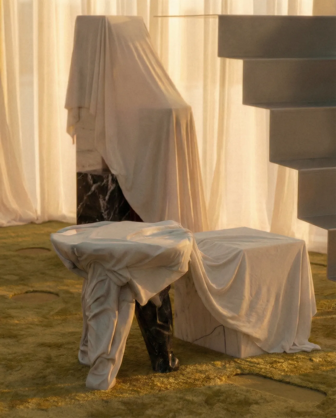 Furniture draped in white fabric in front of sheer curtains